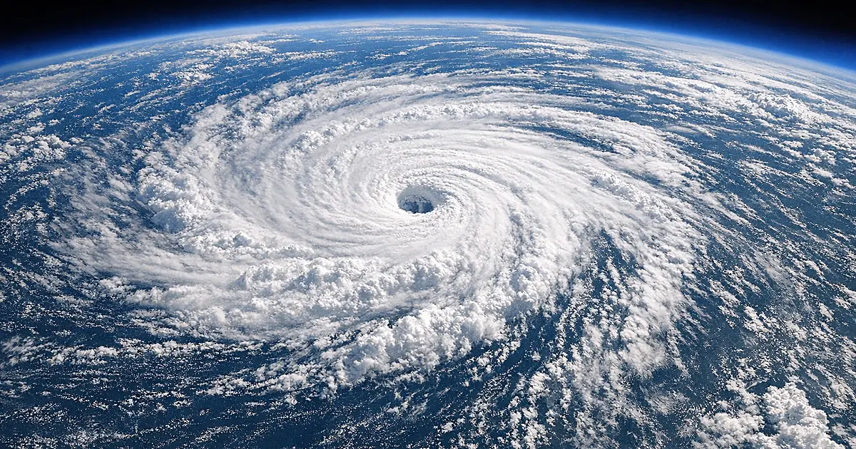 Satellite view of massive hurricane system with defined eye wall over ocean waters