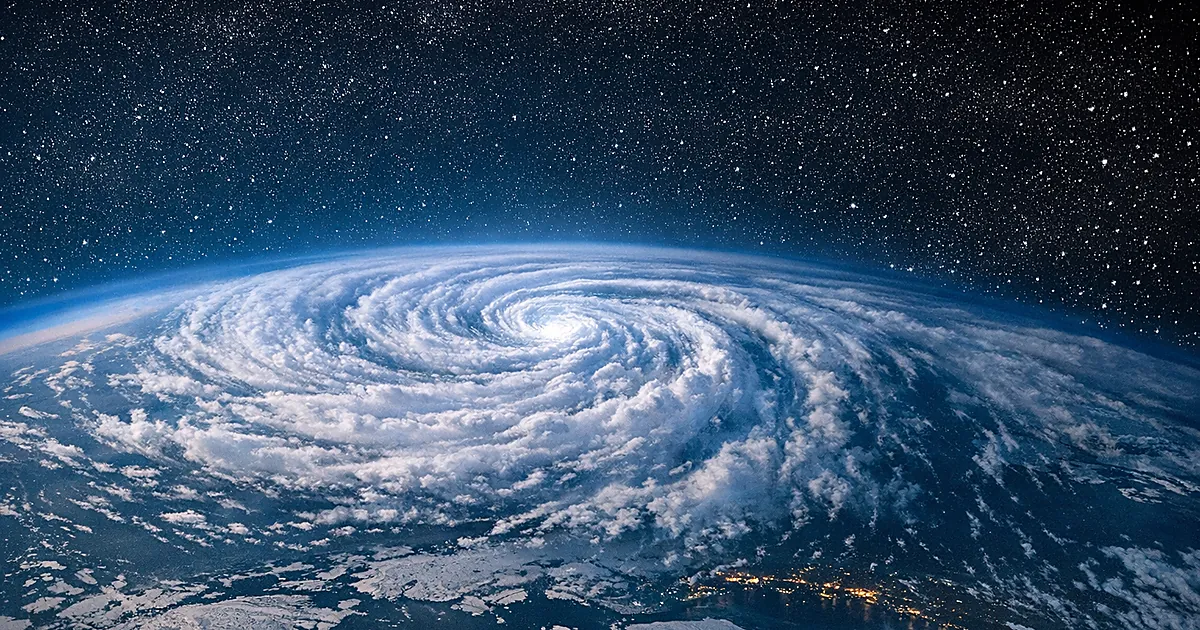 Aerial view of swirling stratospheric clouds over Arctic showing polar vortex formation against twilight sky