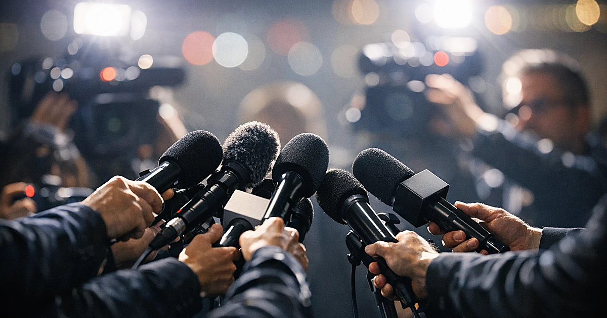 Professional broadcast microphones thrust forward by reporters in a press scrum with dramatic lighting