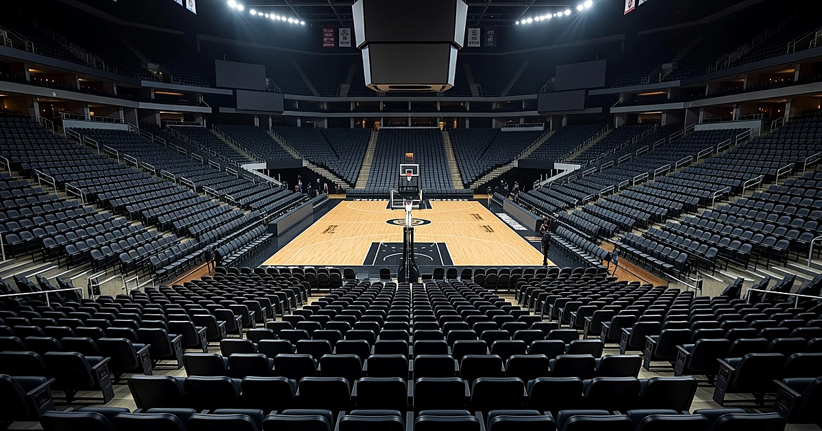Empty arena seating sections overlooking a professional basketball court under bright stadium lighting