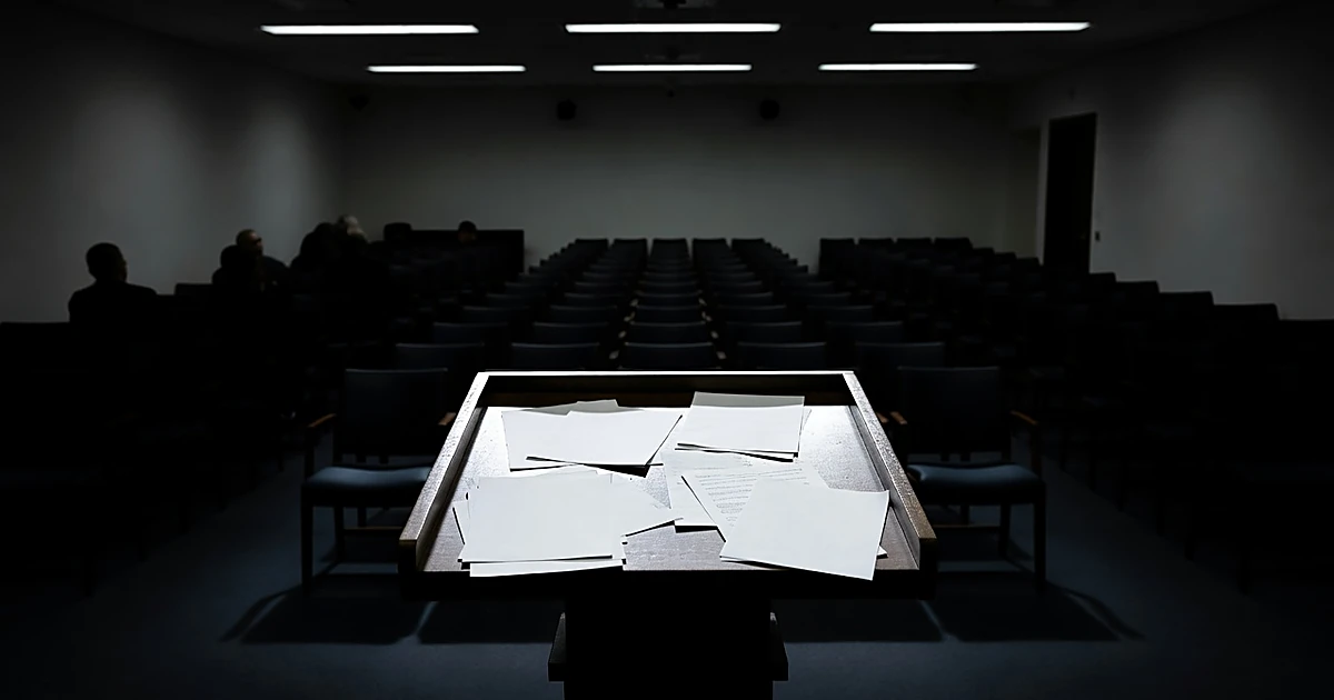 Empty White House press briefing podium under harsh lighting with scattered blank papers at 3 a.m.