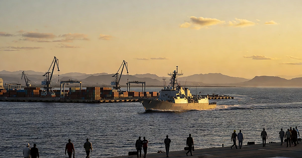 Naval vessel moving through strategic coastal port with shipping infrastructure at sunset