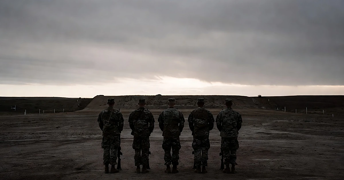Military firing squad formation silhouetted at dawn on Fort Hood training range facing distant earthen berm